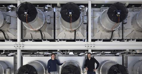 Scientists standing in front of machines