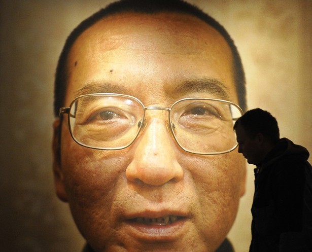 Man Walks By Poster Of Liu Xiaobo