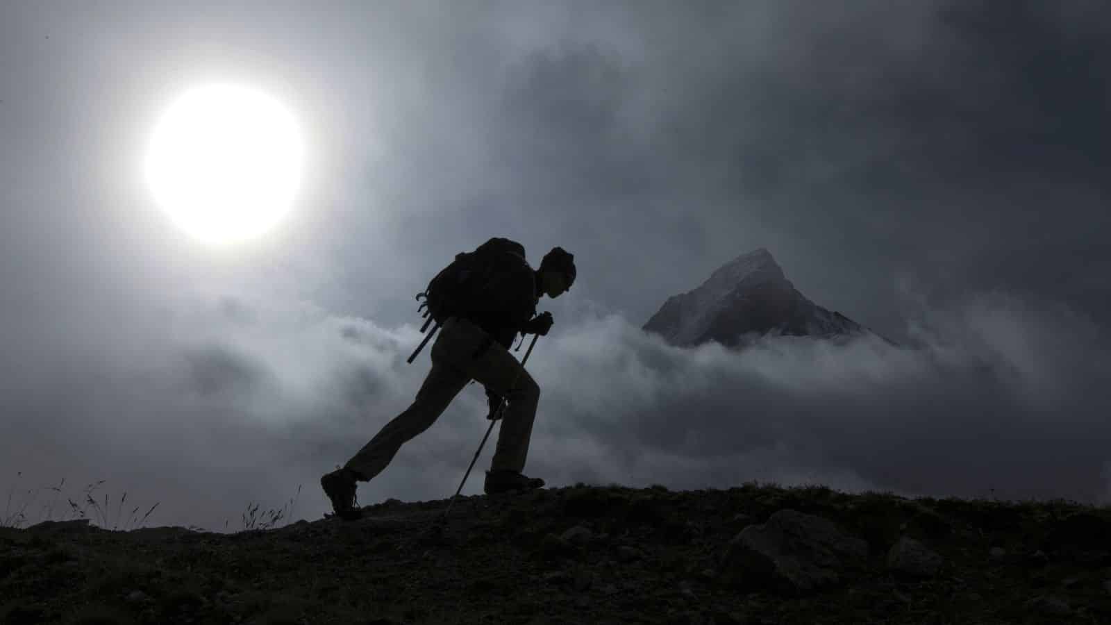 Man Hiking In Dark Mountains