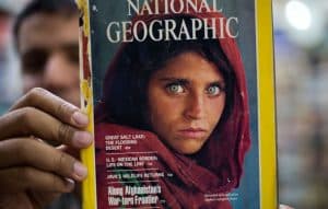 Man Holding Issue of National Geographic