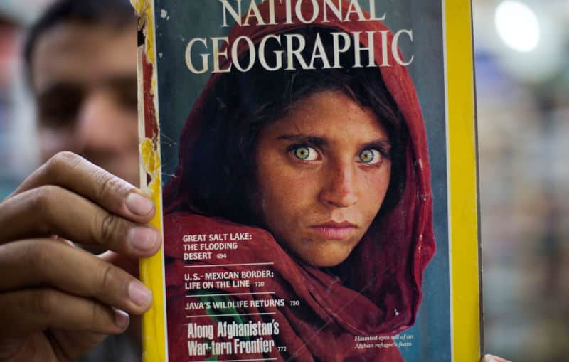 Man Holding Issue of National Geographic